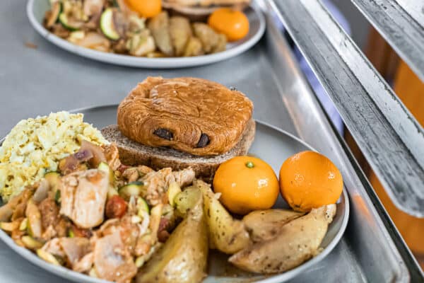 Two plates of food on a metal tray.